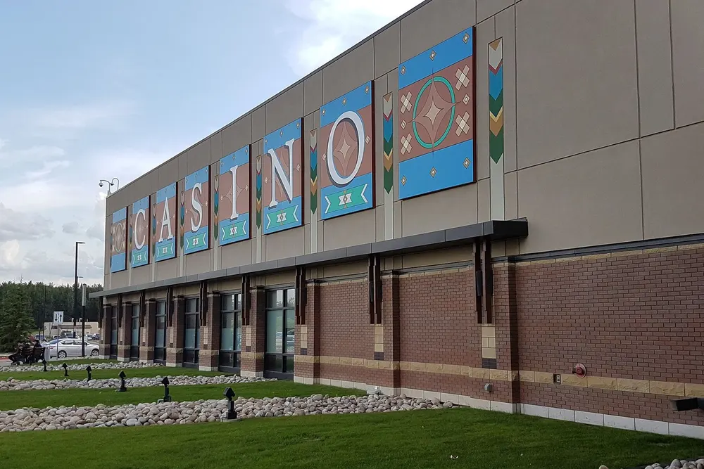 East side of River Cree Resort and Casino, with large painted panels spelling CASINO